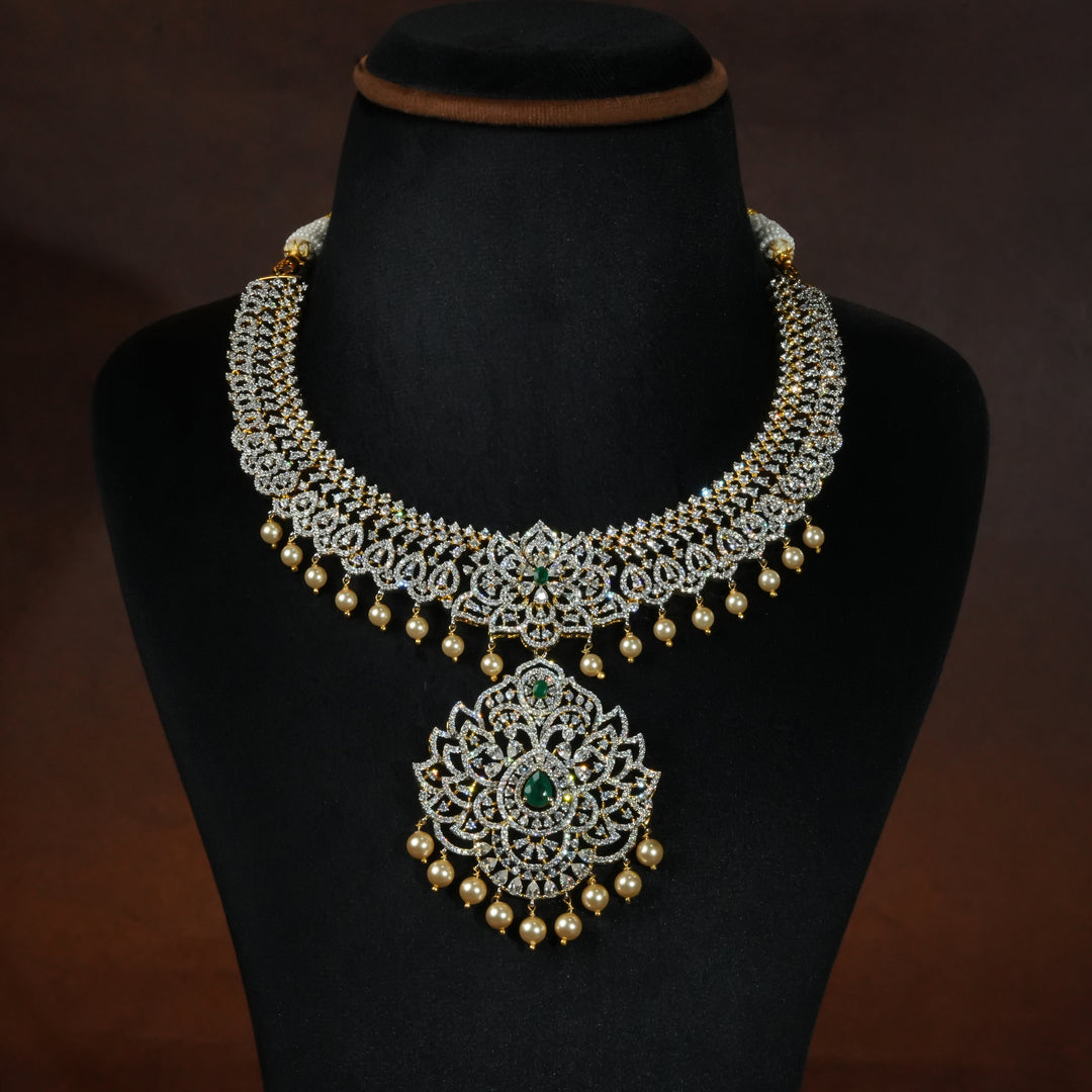 Luxury diamond-look silver necklace with premium cz stones and semi-precious emerald stones in 92.5 silver, bridal wedding jewellery with gold finish by Sri Fine Jewellery Punjagutta Hyderabad.
