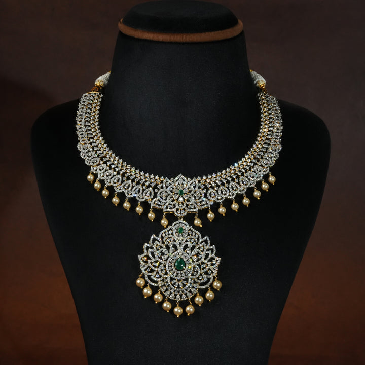 Luxury diamond-look silver necklace with premium cz stones and semi-precious emerald stones in 92.5 silver, bridal wedding jewellery with gold finish by Sri Fine Jewellery Punjagutta Hyderabad.