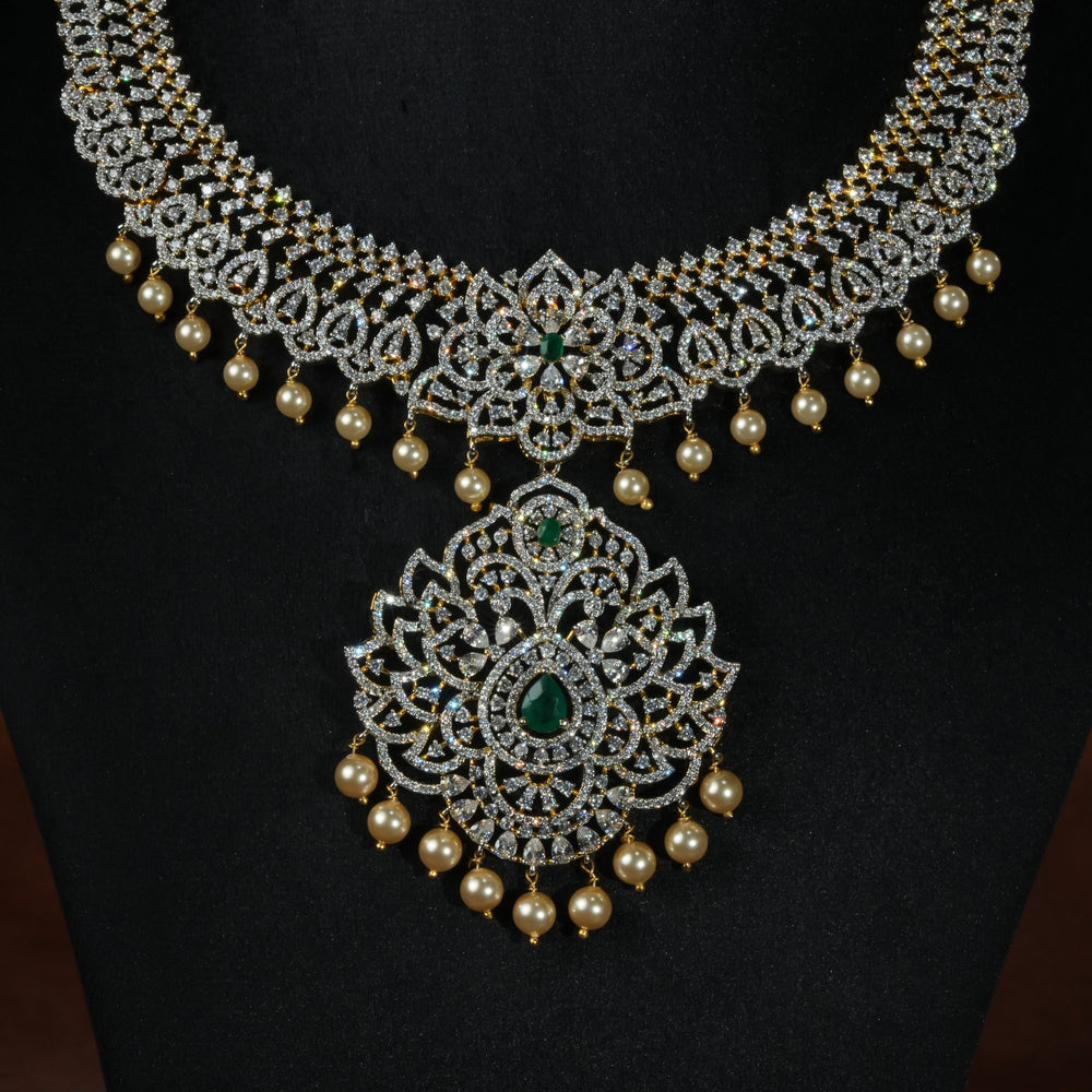 Luxury diamond-look silver necklace with premium cz stones and semi-precious emerald stones in 92.5 silver, bridal wedding jewellery with gold finish by Sri Fine Jewellery Punjagutta Hyderabad.