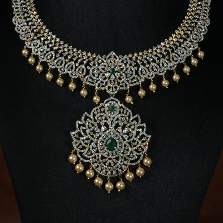 Luxury diamond-look silver necklace with premium cz stones and semi-precious emerald stones in 92.5 silver, bridal wedding jewellery with gold finish by Sri Fine Jewellery Punjagutta Hyderabad.