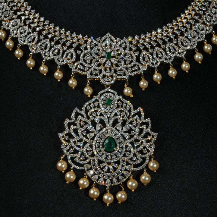 Luxury diamond-look silver necklace with premium cz stones and semi-precious emerald stones in 92.5 silver, bridal wedding jewellery with gold finish by Sri Fine Jewellery Punjagutta Hyderabad.