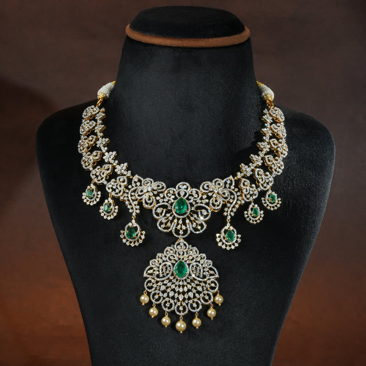 Luxury diamond-look silver necklace with premium cz stones and semi-precious emerald stones in 92.5 silver, bridal wedding jewellery with gold finish by Sri Fine Jewellery Punjagutta Hyderabad.