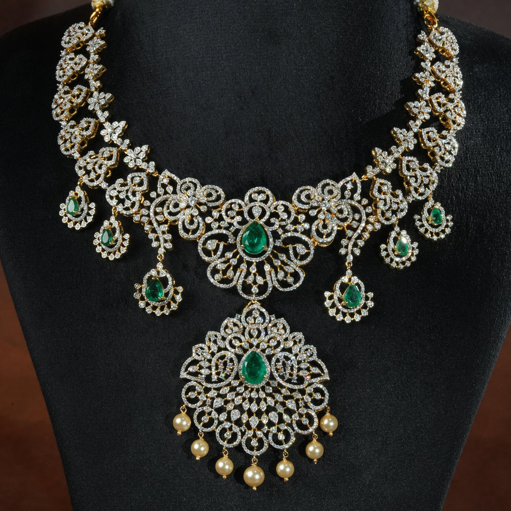 Luxury diamond-look silver necklace with premium cz stones and semi-precious emerald stones in 92.5 silver, bridal wedding jewellery with gold finish by Sri Fine Jewellery Punjagutta Hyderabad.