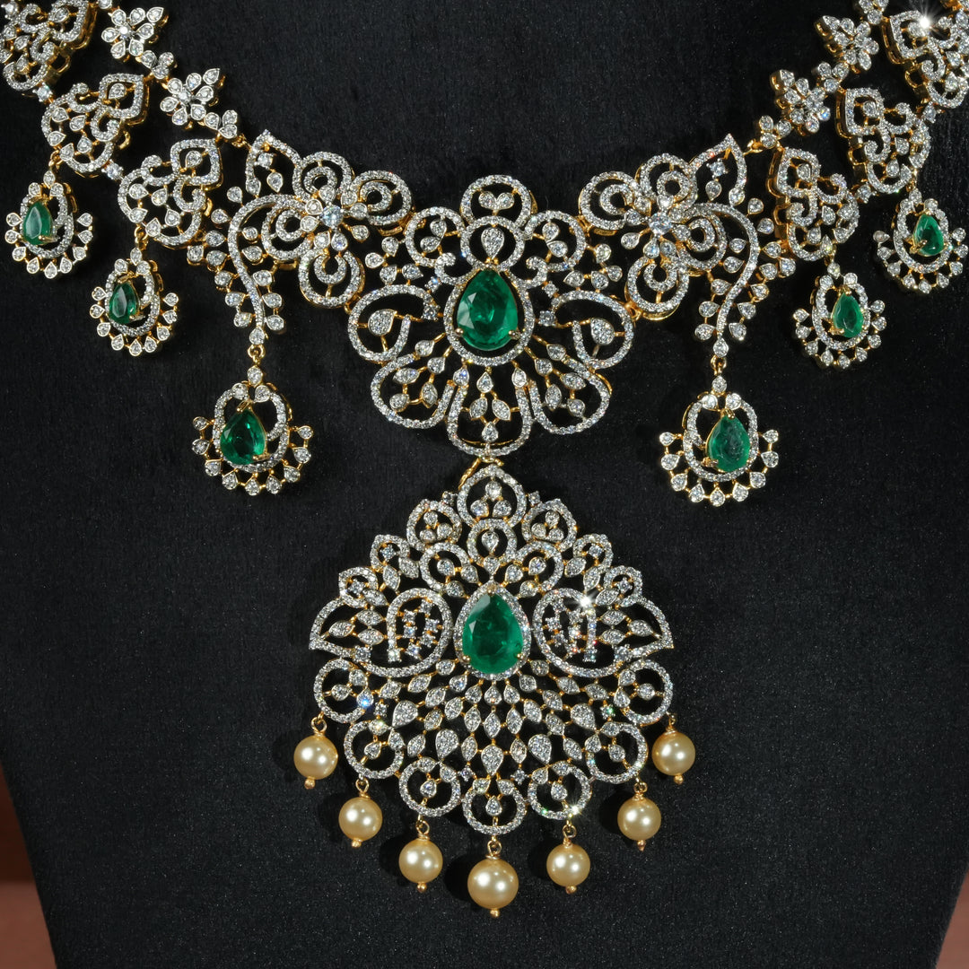 Luxury diamond-look silver necklace with premium cz stones and semi-precious emerald stones in 92.5 silver, bridal wedding jewellery with gold finish by Sri Fine Jewellery Punjagutta Hyderabad.