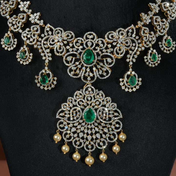 Luxury diamond-look silver necklace with premium cz stones and semi-precious emerald stones in 92.5 silver, bridal wedding jewellery with gold finish by Sri Fine Jewellery Punjagutta Hyderabad.