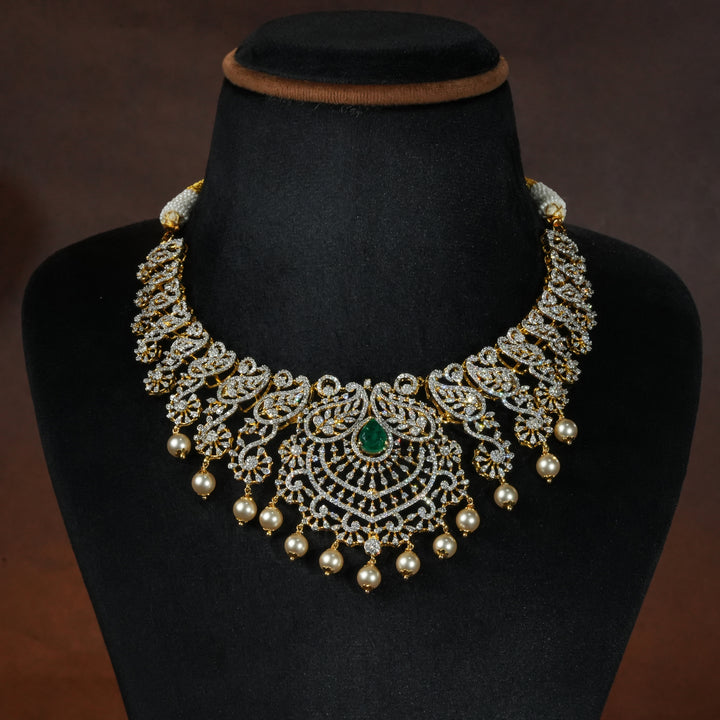 Luxury diamond-look silver necklace with premium cz stones, semi-precious emerald stones and mango motifs in 92.5 silver, bridal wedding jewellery with gold finish by Sri Fine Jewellery Punjagutta Hyderabad.