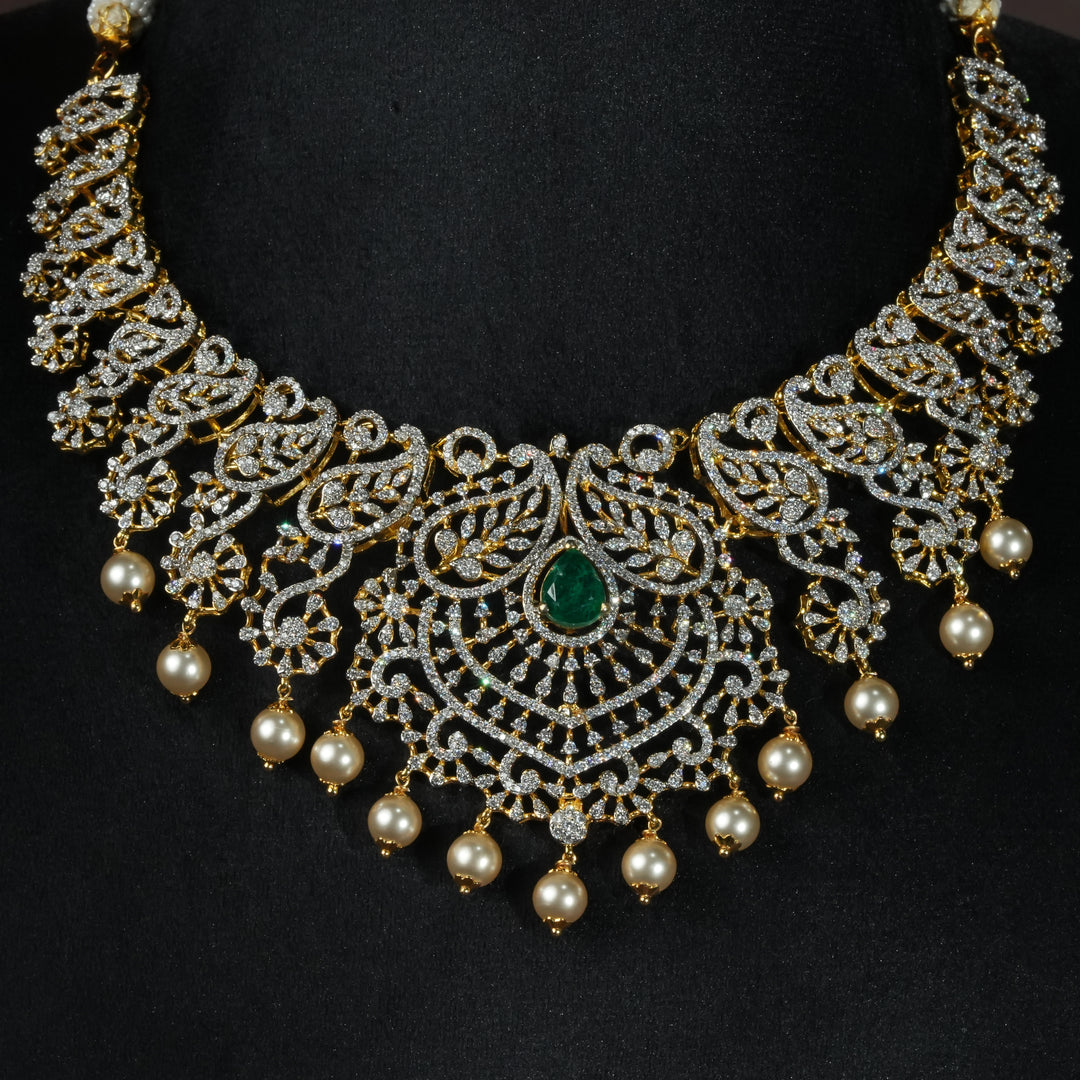 Luxury diamond-look silver necklace with premium cz stones, semi-precious emerald stones and mango motifs in 92.5 silver, bridal wedding jewellery with gold finish by Sri Fine Jewellery Punjagutta Hyderabad.