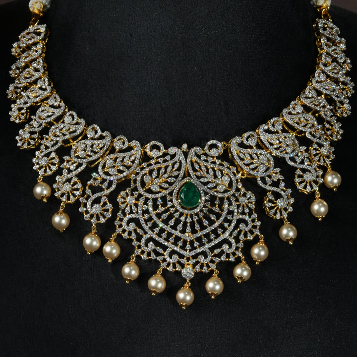 Luxury diamond-look silver necklace with premium cz stones, semi-precious emerald stones and mango motifs in 92.5 silver, bridal wedding jewellery with gold finish by Sri Fine Jewellery Punjagutta Hyderabad.