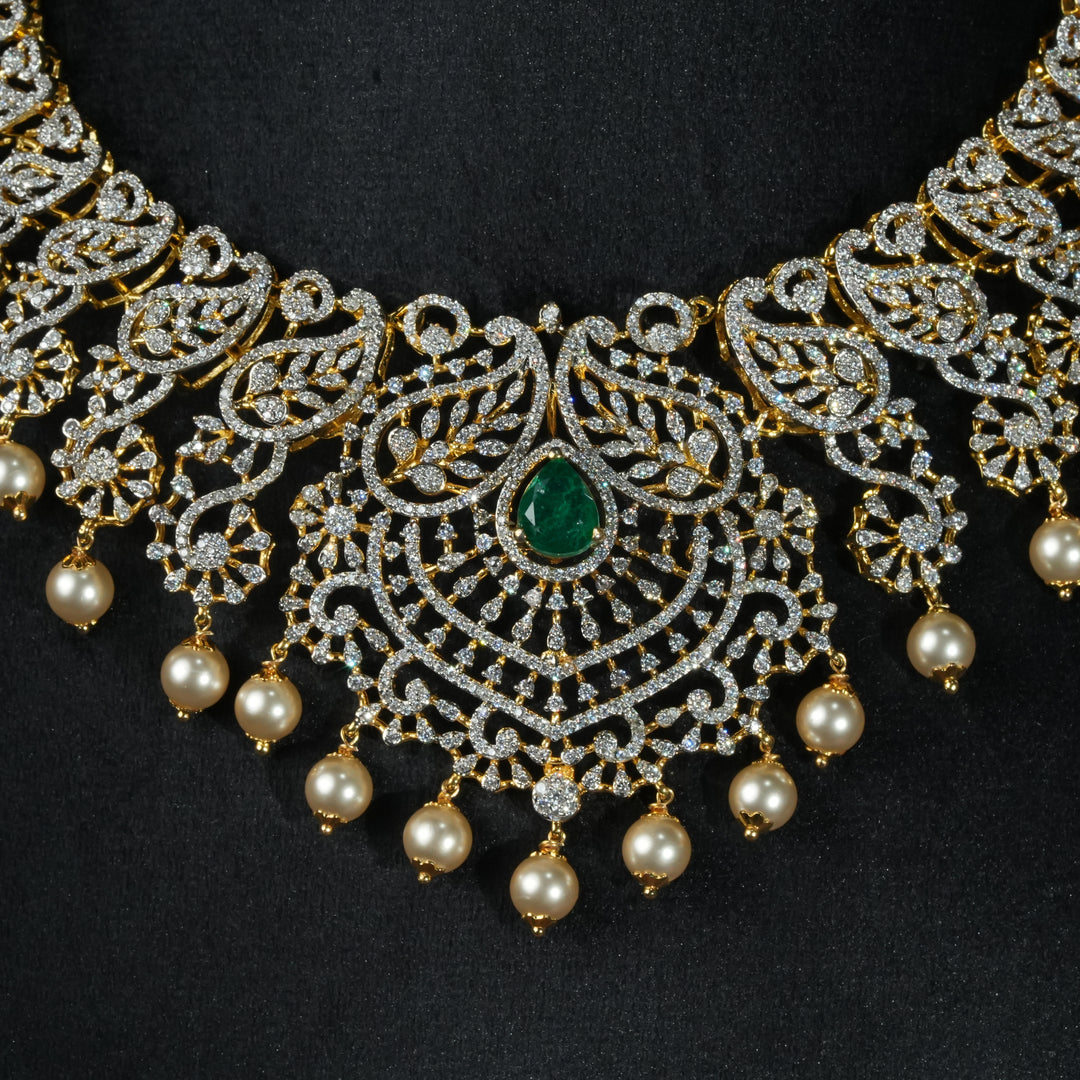 Luxury diamond-look silver necklace with premium cz stones and semi-precious emerald stones in 92.5 silver, bridal wedding jewellery with gold finish by Sri Fine Jewellery Punjagutta Hyderabad.