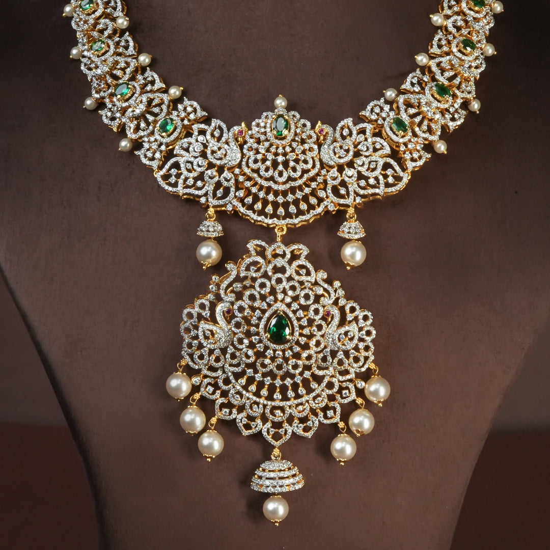 Handcrafted designer 92.5 silver cz emerald necklace with premium cz, semi precious emerald embellishments and peacock motifs . Perfect for bridal wear, festive occasions, weddings, and traditional ethnic styling.
Sri fine jewellery, Hyderabad. 