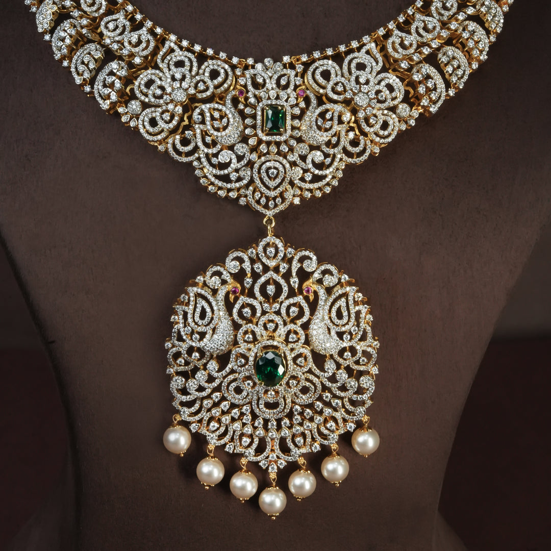 Close-up view of handcrafted designer 92.5 silver cz emerald necklace with premium cz, semi precious emerald embellishments and peacock motifs. Perfect for bridal wear, festive occasions, weddings, and traditional ethnic styling.
Sri fine jewellery, Hyderabad. 