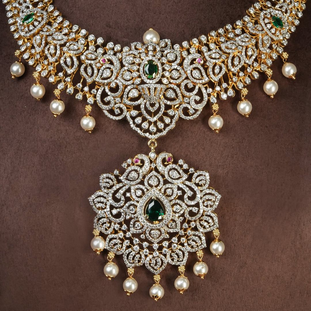 Close-up view of handcrafted designer 92.5 silver cz emerald necklace with premium cz, semi precious emerald embellishments and peacock motifs. Perfect for bridal wear, festive occasions, weddings, and traditional ethnic styling.
Sri fine jewellery, Hyderabad. 