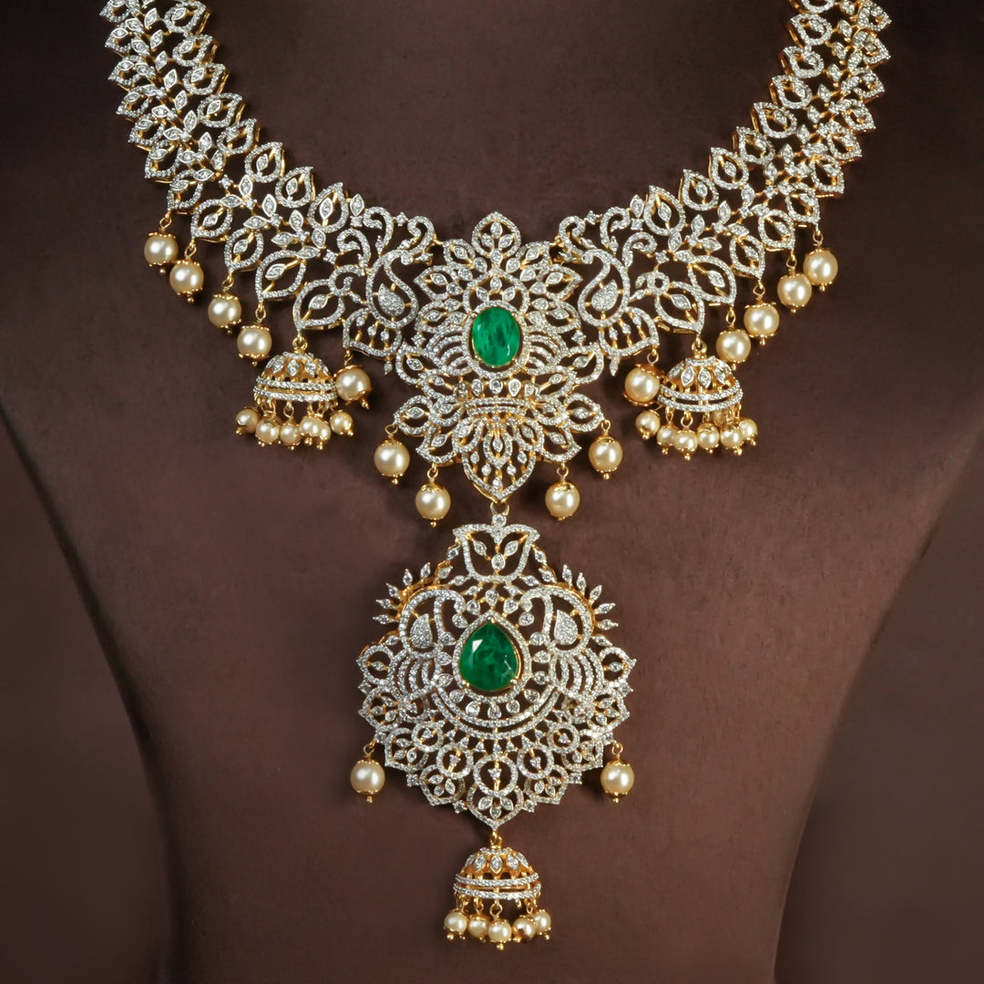 Handcrafted designer 92.5 silver cz emerald necklace with premium cz and semi precious emerald embellishments . Perfect for bridal wear, festive occasions, weddings, and traditional ethnic styling.
Sri fine jewellery, Hyderabad. 