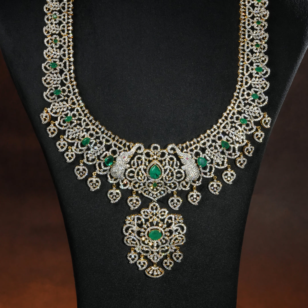 Close-up of luxury bridal necklace set in 92.5 silver with emerald green stones, antique finish and intricate design, handcrafted wedding jewellery for brides by Sri Fine Jewellery, Hyderabd(https://srifinejewellery.com)