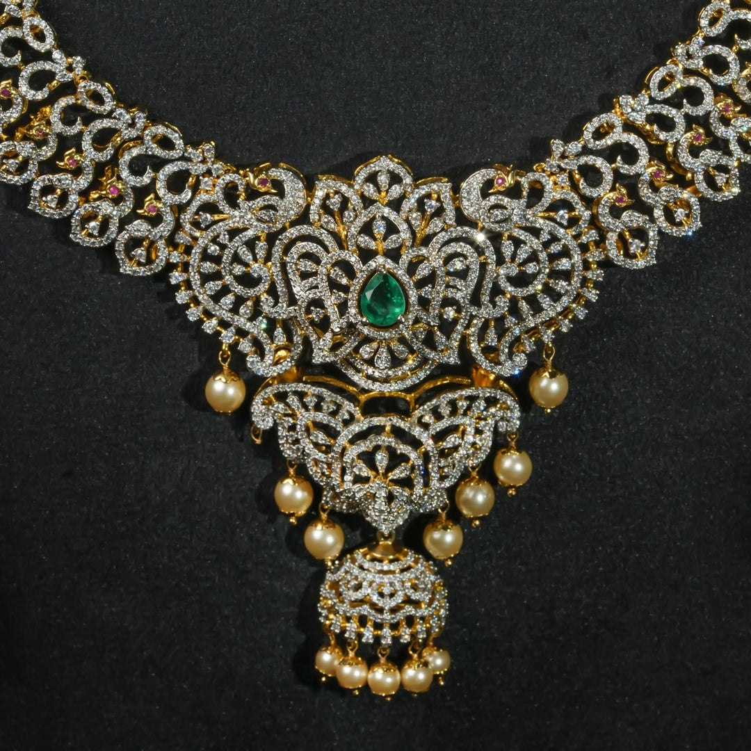 Close-up of luxury bridal necklace set in 92.5 silver with emerald green stones, antique finish and intricate design, handcrafted wedding jewellery for brides by Sri Fine Jewellery, Hyderabd(https://srifinejewellery.com)
