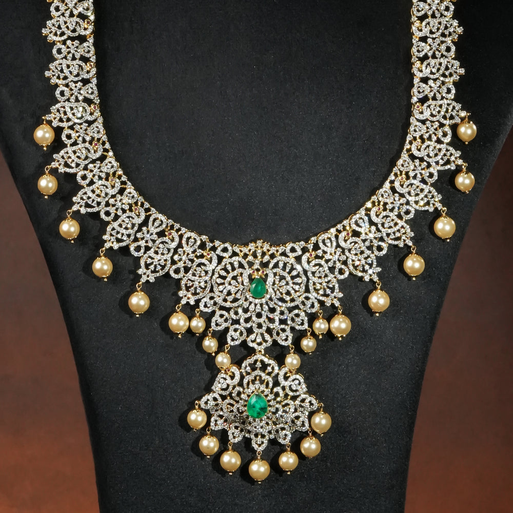 Close-up of luxury bridal necklace set in 92.5 silver with emerald green stones, antique finish and intricate victorian floral design, handcrafted wedding jewellery for brides by Sri Fine Jewellery, Hyderabd(https://srifinejewellery.com)