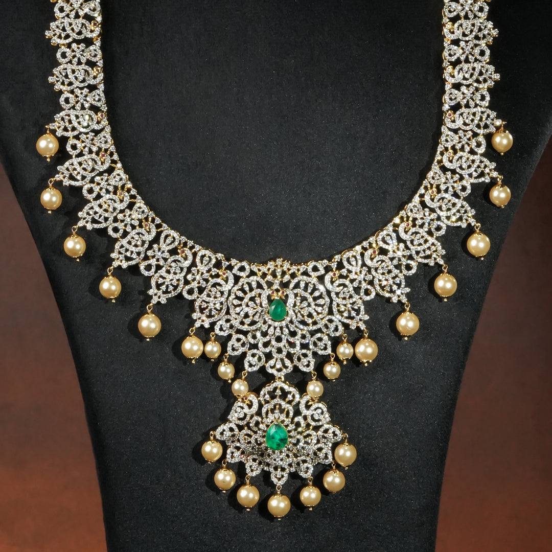 Close-up of luxury bridal necklace set in 92.5 silver with emerald green stones, antique finish and intricate victorian floral design, handcrafted wedding jewellery for brides by Sri Fine Jewellery, Hyderabd(https://srifinejewellery.com)