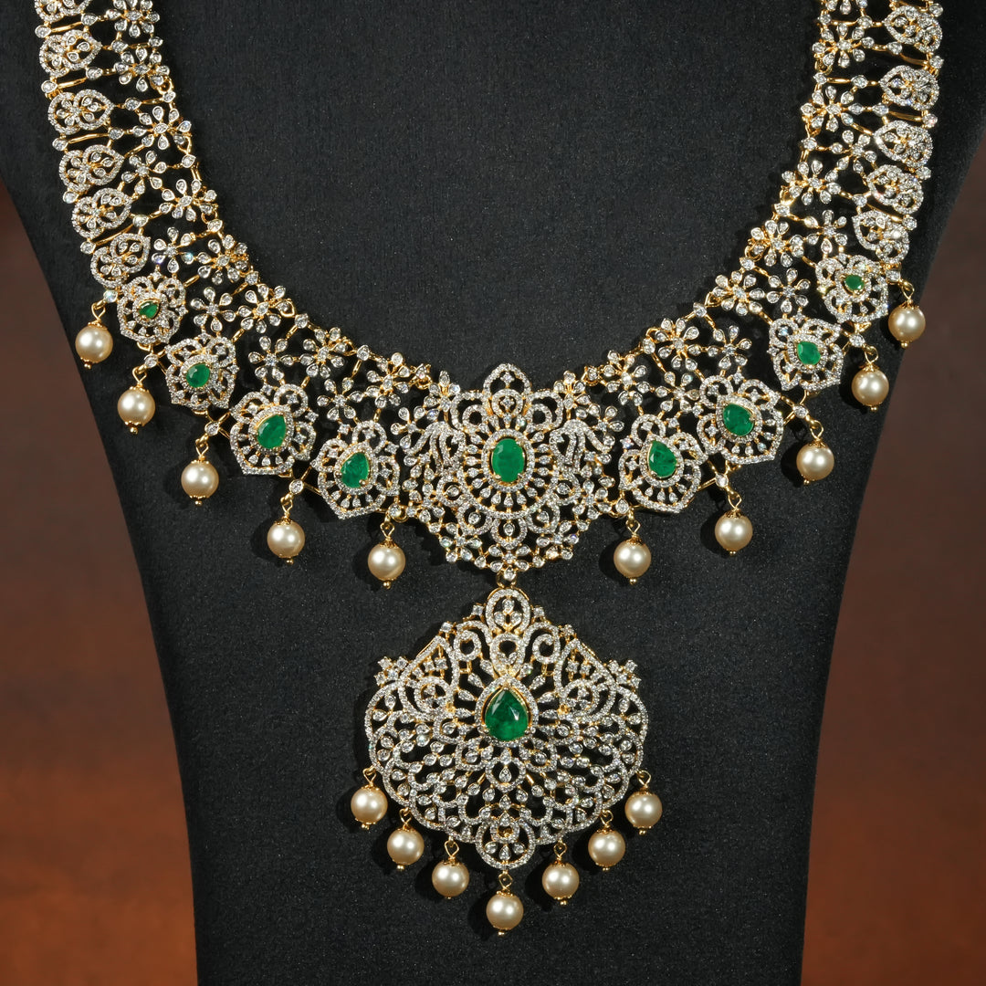 Close-up of luxury bridal necklace set in 92.5 silver with emerald green stones, antique finish and intricate victorian floral design, handcrafted wedding jewellery for brides by Sri Fine Jewellery, Hyderabd(https://srifinejewellery.com)