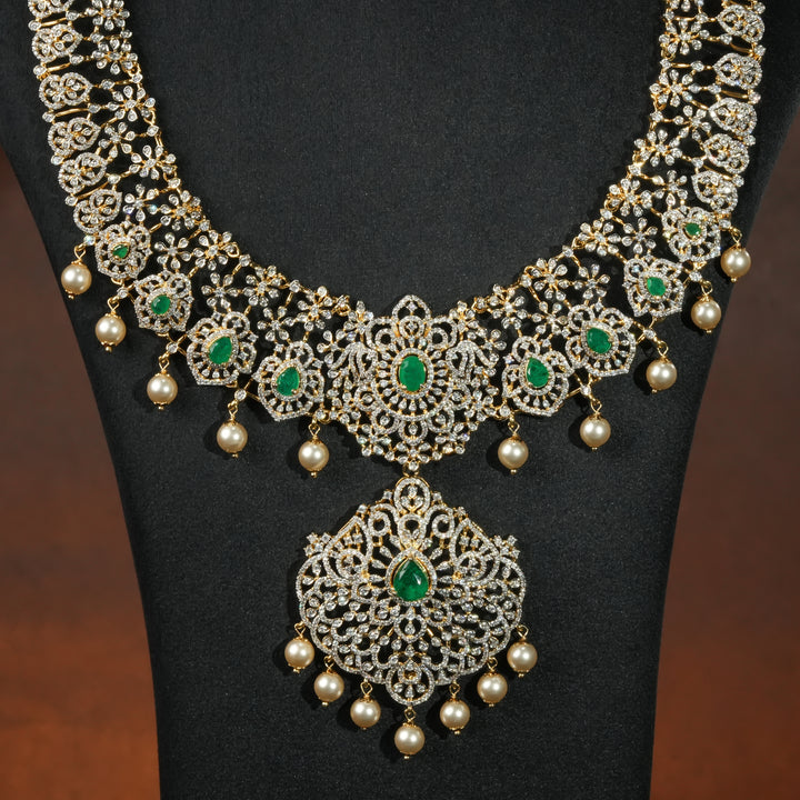 Close-up of luxury bridal necklace set in 92.5 silver with emerald green stones, antique finish and intricate victorian floral design, handcrafted wedding jewellery for brides by Sri Fine Jewellery, Hyderabd(https://srifinejewellery.com)