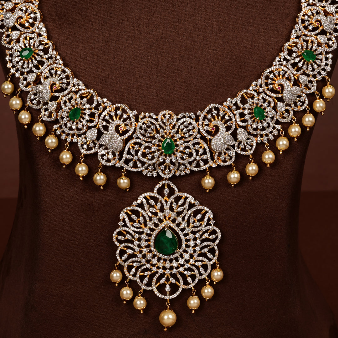 Close-up view of luxury bridal necklace set in 92.5 silver with emerald green stones, antique finish, peacock motifs and intricate victorian floral design, handcrafted wedding jewellery for brides by Sri Fine Jewellery, Hyderabd(https://srifinejewellery.com)