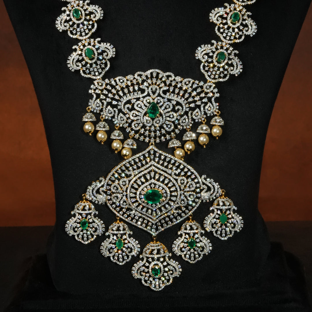 Close-up of luxury bridal necklace set in 92.5 silver with emerald green stones, antique finish and intricate victorian floral design, handcrafted wedding jewellery for brides by Sri Fine Jewellery, Hyderabd(https://srifinejewellery.com)