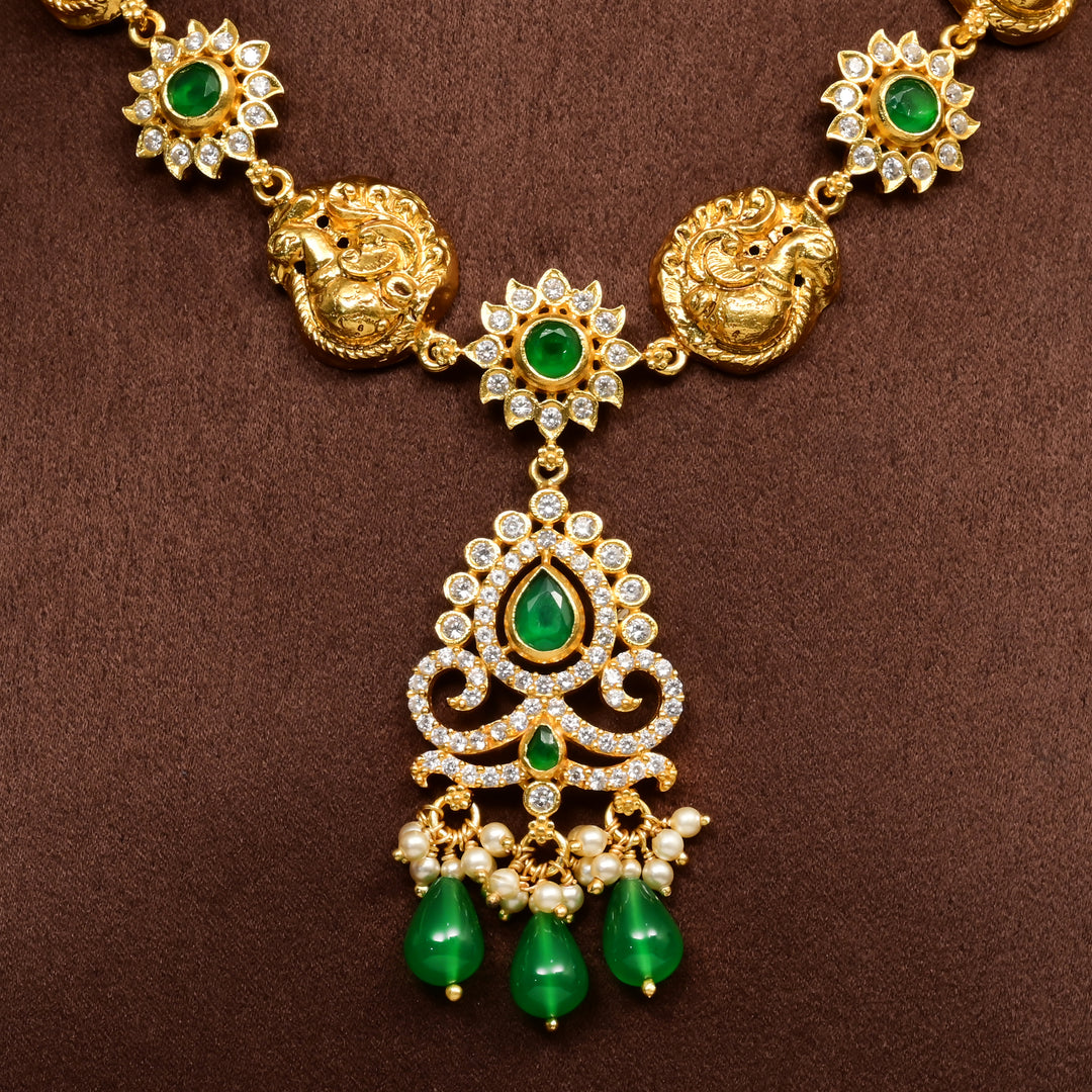 Close-up of traditional 92.5 silver temple necklace with Lakshmi and peacock motifs, emerald stone detailing, and intricate heritage craftsmanship by Sri Fine Jewellery Hyderabad (https://srifinejewellery.com)