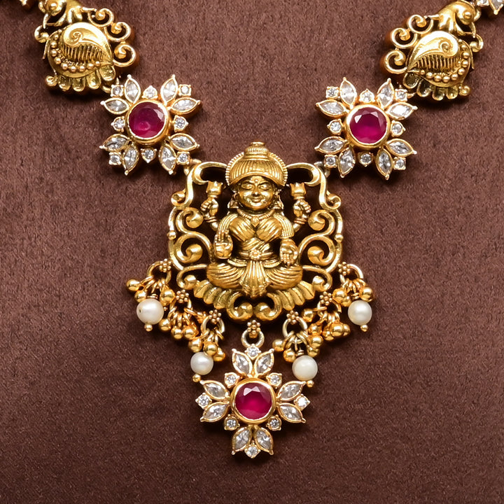 Close-up view of 92.5 silver temple necklace with Lakshmi and floral motifs, ruby stone detailing, and intricate heritage craftsmanship by Sri Fine Jewellery Hyderabad (https://srifinejewellery.com)
