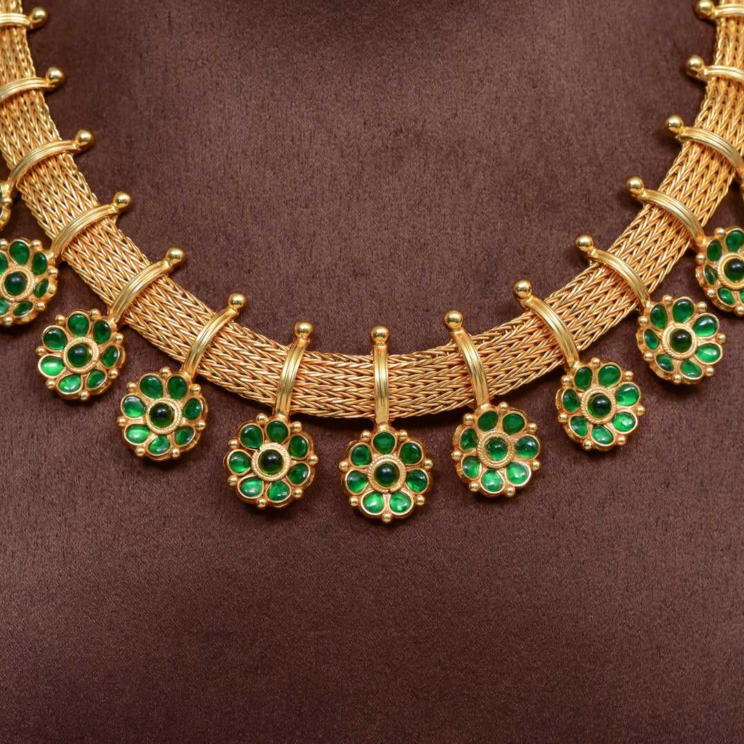 Traditional 92.5 silver temple necklace set with floral motifs, emerald stone detailing, and intricate heritage craftsmanship by Sri Fine Jewellery Hyderabad (https://srifinejewellery.com)