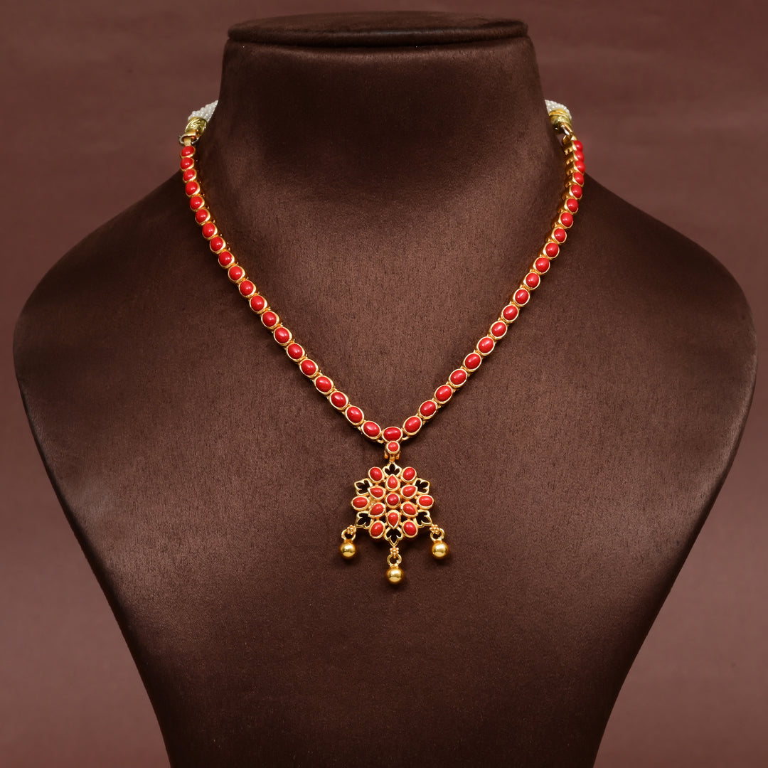 Red stone floral pendant necklace in premium 92.5 sterling silver with antique gold finish, elegant traditional jewellery design for women, handcrafted festive and wedding wear necklace by Sri Fine Jewellery, Hyderabad.
