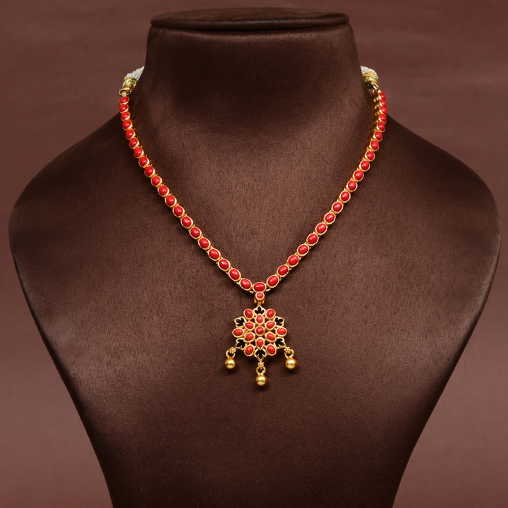 Red stone floral pendant necklace in premium 92.5 sterling silver with antique gold finish, elegant traditional jewellery design for women, handcrafted festive and wedding wear necklace by Sri Fine Jewellery, Hyderabad.
