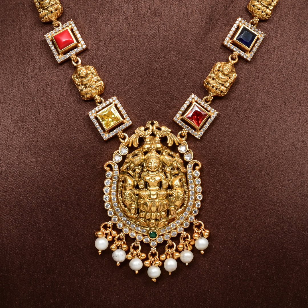 92.5 silver temple necklace with Lakshmi pendant, multicolor stones, pearl drops, and antique gold finish — perfect for bridal and festive wear.
Sri fine jewellery, Hyderabad 