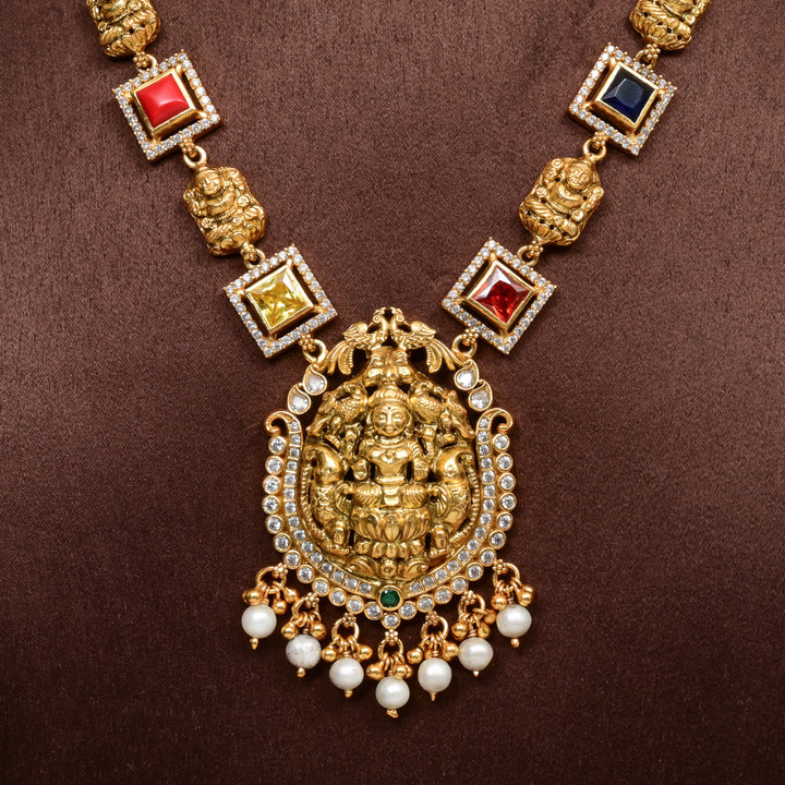 92.5 silver temple necklace with Lakshmi pendant, multicolor stones, pearl drops, and antique gold finish — perfect for bridal and festive wear.
Sri fine jewellery, Hyderabad 