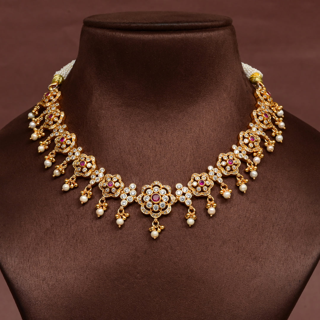 92.5 silver floral necklace with cz stones, ruby accents, pearl drops, and gold finish design by Sri Fine Jewellery Hyderabad.