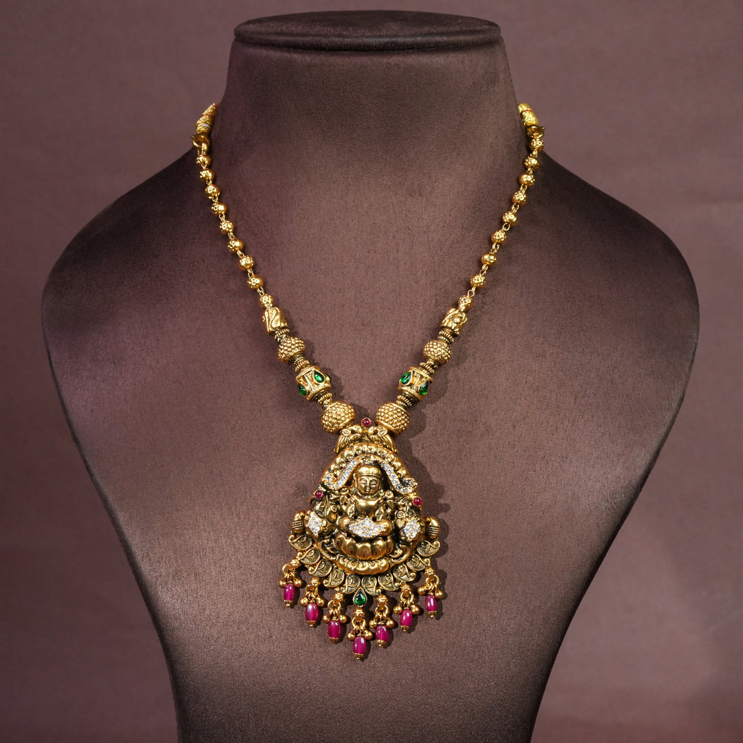 92.5 silver temple necklace with Lakshmi pendant, cz stone accents, antique gold finish, and traditional South Indian bridal jewellery design by Sri Fine Jewellery Hyderabad.
