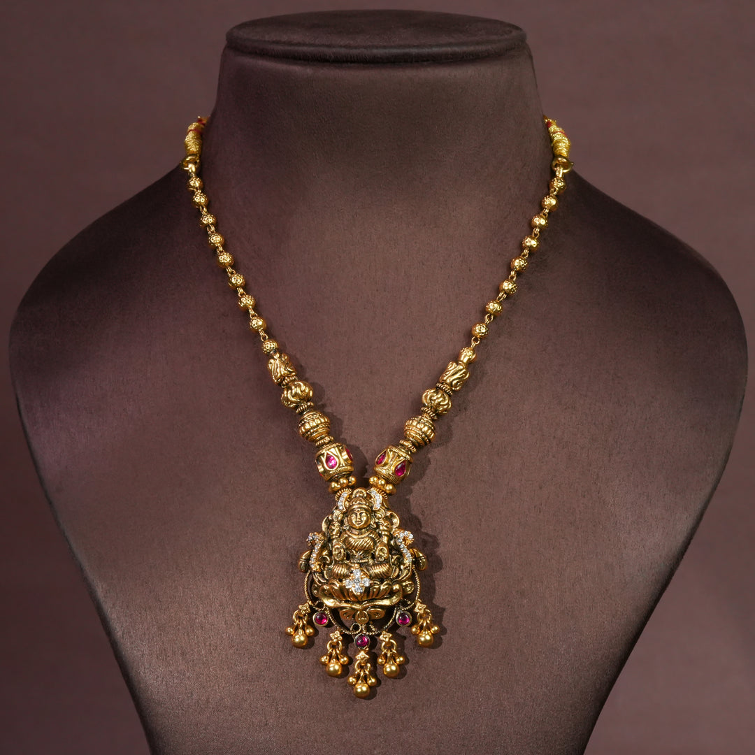 92.5 sterling silver temple choker necklace with Lakshmi pendant, ruby stone accents, antique gold finish, and traditional South Indian bridal jewellery design by Sri Fine Jewellery Hyderabad.