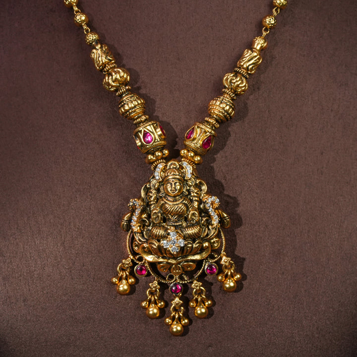 92.5 sterling silver temple choker necklace with Lakshmi pendant, ruby stone accents, antique gold finish, and traditional South Indian bridal jewellery design by Sri Fine Jewellery Hyderabad.