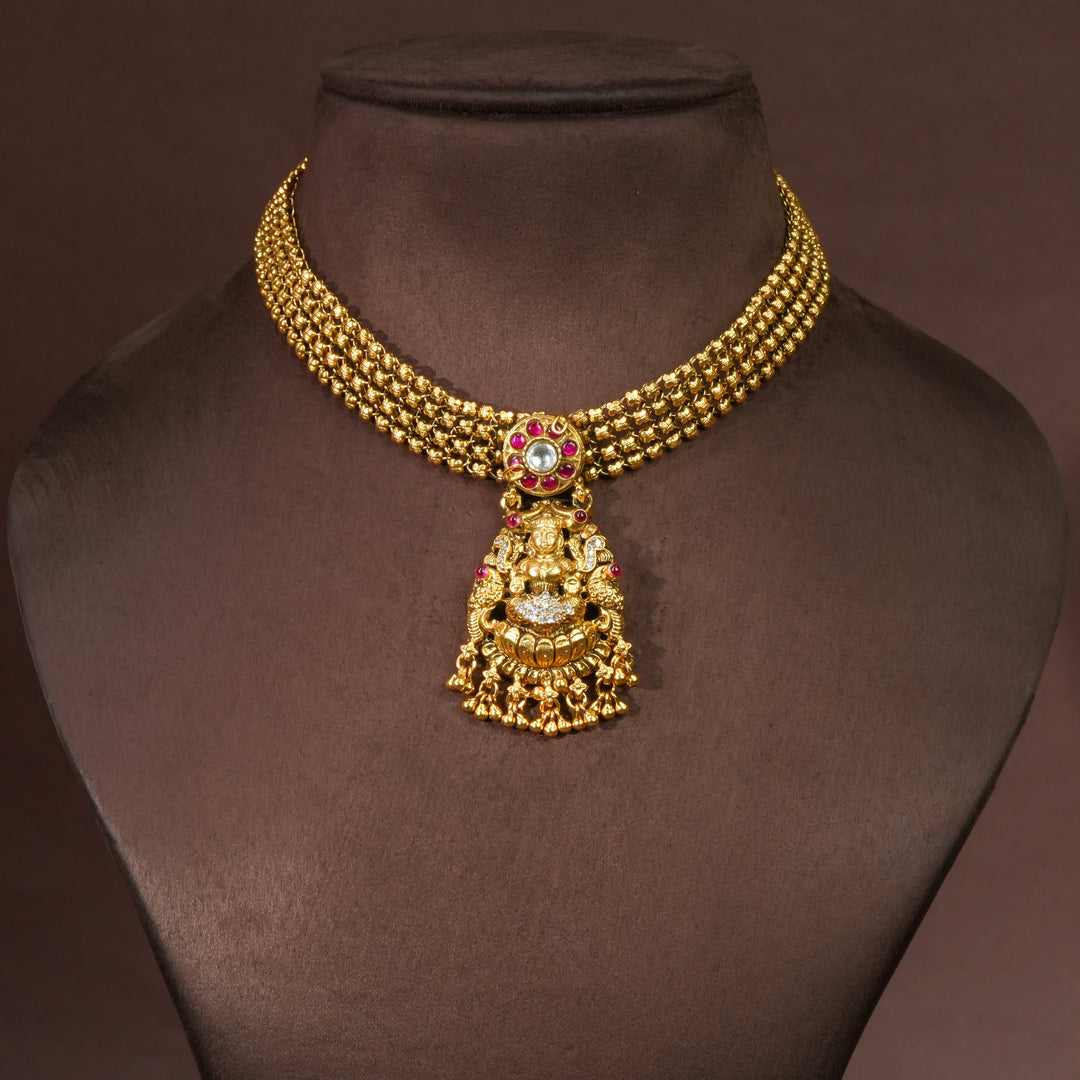 92.5 sterling silver temple choker necklace with Lakshmi pendant, ruby stone accents, antique gold finish, and traditional South Indian bridal jewellery design by Sri Fine Jewellery Hyderabad.
