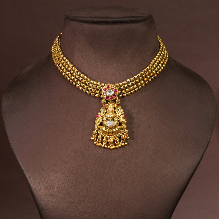 92.5 sterling silver temple choker necklace with Lakshmi pendant, ruby stone accents, antique gold finish, and traditional South Indian bridal jewellery design by Sri Fine Jewellery Hyderabad.
