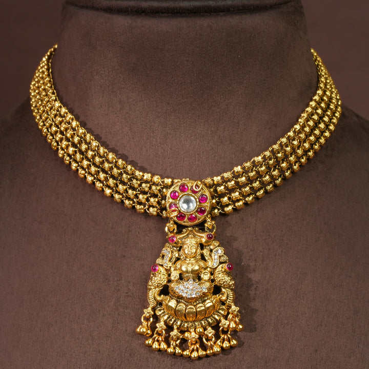 92.5 sterling silver temple choker necklace with Lakshmi pendant, ruby stone accents, antique gold finish, and traditional South Indian bridal jewellery design by Sri Fine Jewellery Hyderabad.
