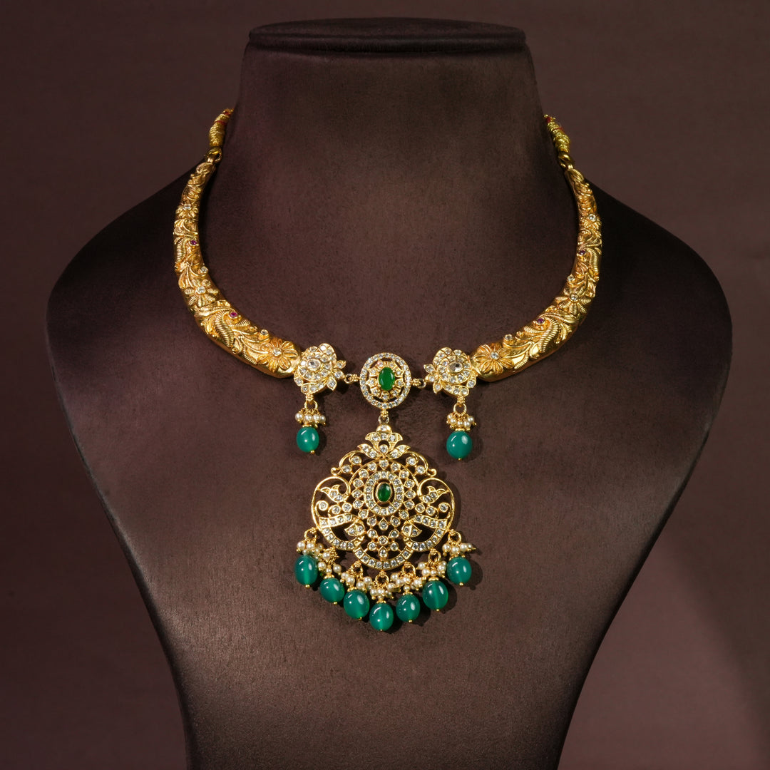 92.5 sterling silver antique necklace with emerald green stone drops, intricate floral detailing, temple-inspired craftsmanship, and gold-finish elegance by Sri Fine Jewellery Hyderabad.
