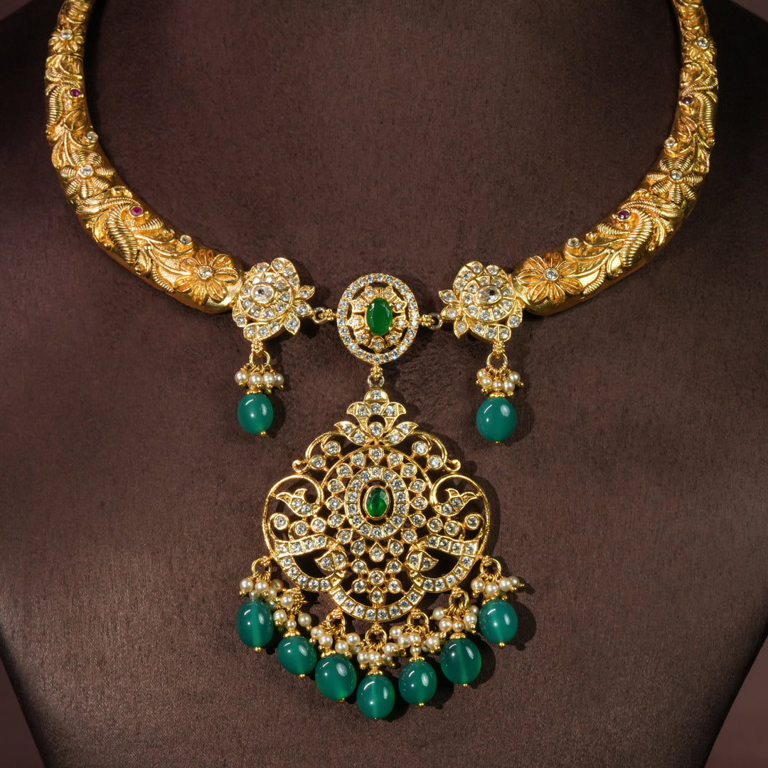 92.5 sterling silver antique necklace with emerald green stone drops, intricate floral detailing, temple-inspired craftsmanship, and gold-finish elegance by Sri Fine Jewellery Hyderabad.
