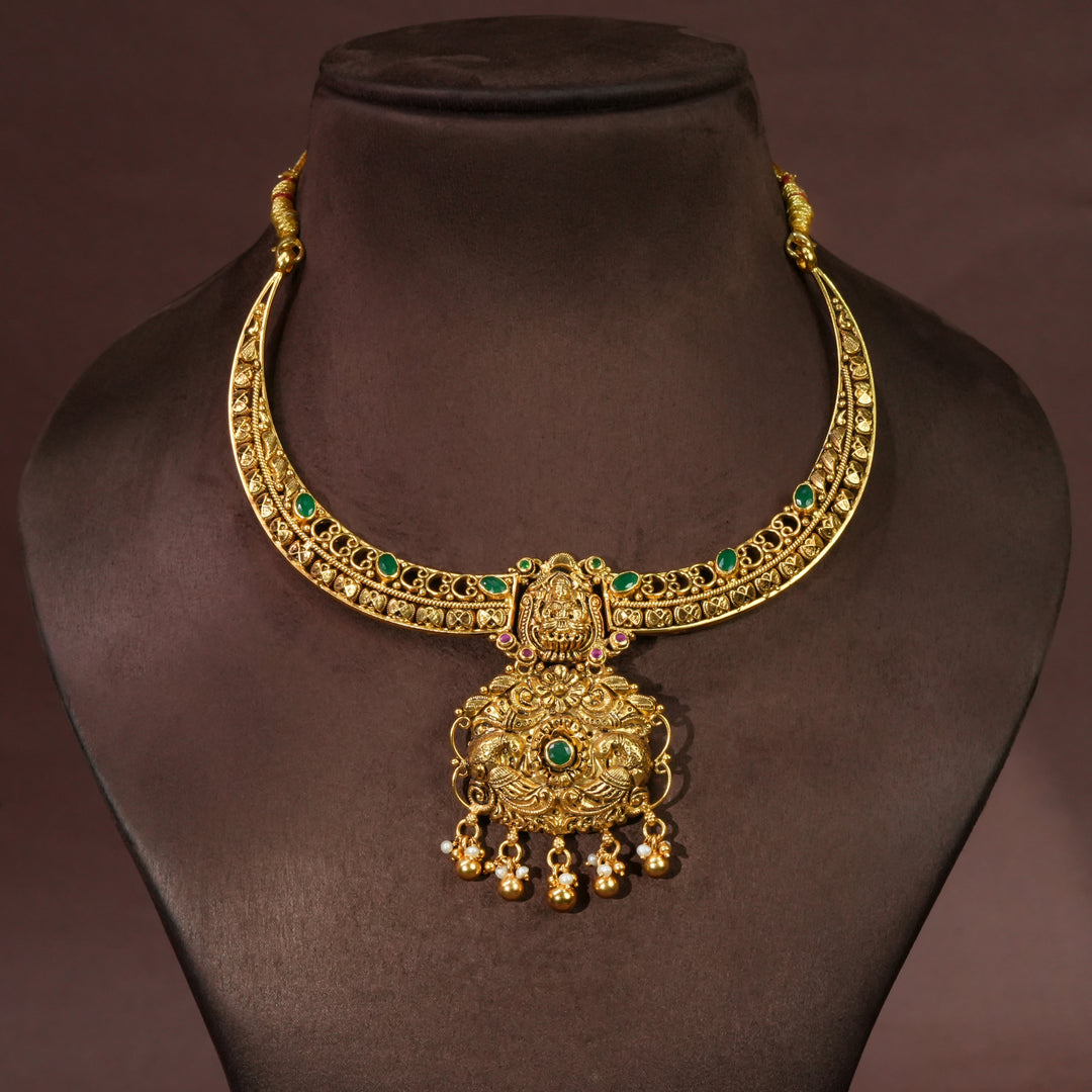 Antique Lakshmi temple necklace in 92.5 sterling silver with gold finish, green stone detailing, handcrafted South Indian bridal jewellery and traditional heritage pendant design by Sri Fine Jewellery Hyderabad.

