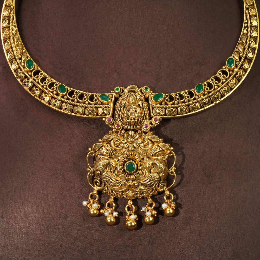 Antique Lakshmi temple necklace in 92.5 sterling silver with gold finish, green stone detailing, handcrafted South Indian bridal jewellery and traditional heritage pendant design by Sri Fine Jewellery Hyderabad.

