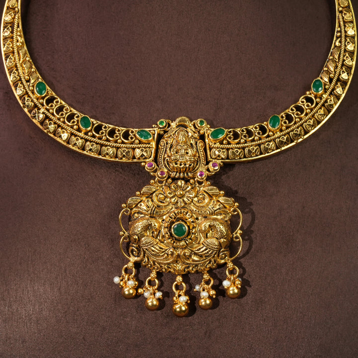 Antique Lakshmi temple necklace in 92.5 sterling silver with gold finish, green stone detailing, handcrafted South Indian bridal jewellery and traditional heritage pendant design by Sri Fine Jewellery Hyderabad.

