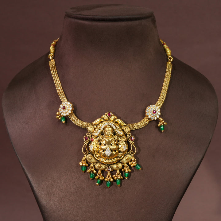 Traditional Lakshmi temple necklace in 92.5 silver with antique gold finish, cz stone detailing, green bead drops and handcrafted South Indian bridal jewellery design by Sri Fine Jewellery Hyderabad.
(https://srifinejewellery.com)
