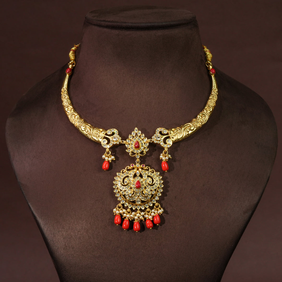 Elegant traditional 92.5 sterling silver temple necklace with antique gold finish, cz stones, red bead drops and intricate handcrafted pendant design by Sri Fine Jewellery Hyderabad.
(https://srifinejewellery.com)