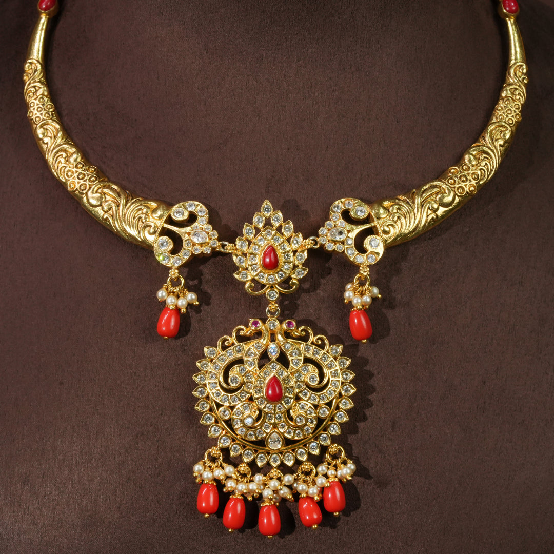Elegant traditional 92.5 sterling silver temple necklace with antique gold finish, cz stones, red bead drops and intricate handcrafted pendant design by Sri Fine Jewellery Hyderabad.
(https://srifinejewellery.com)