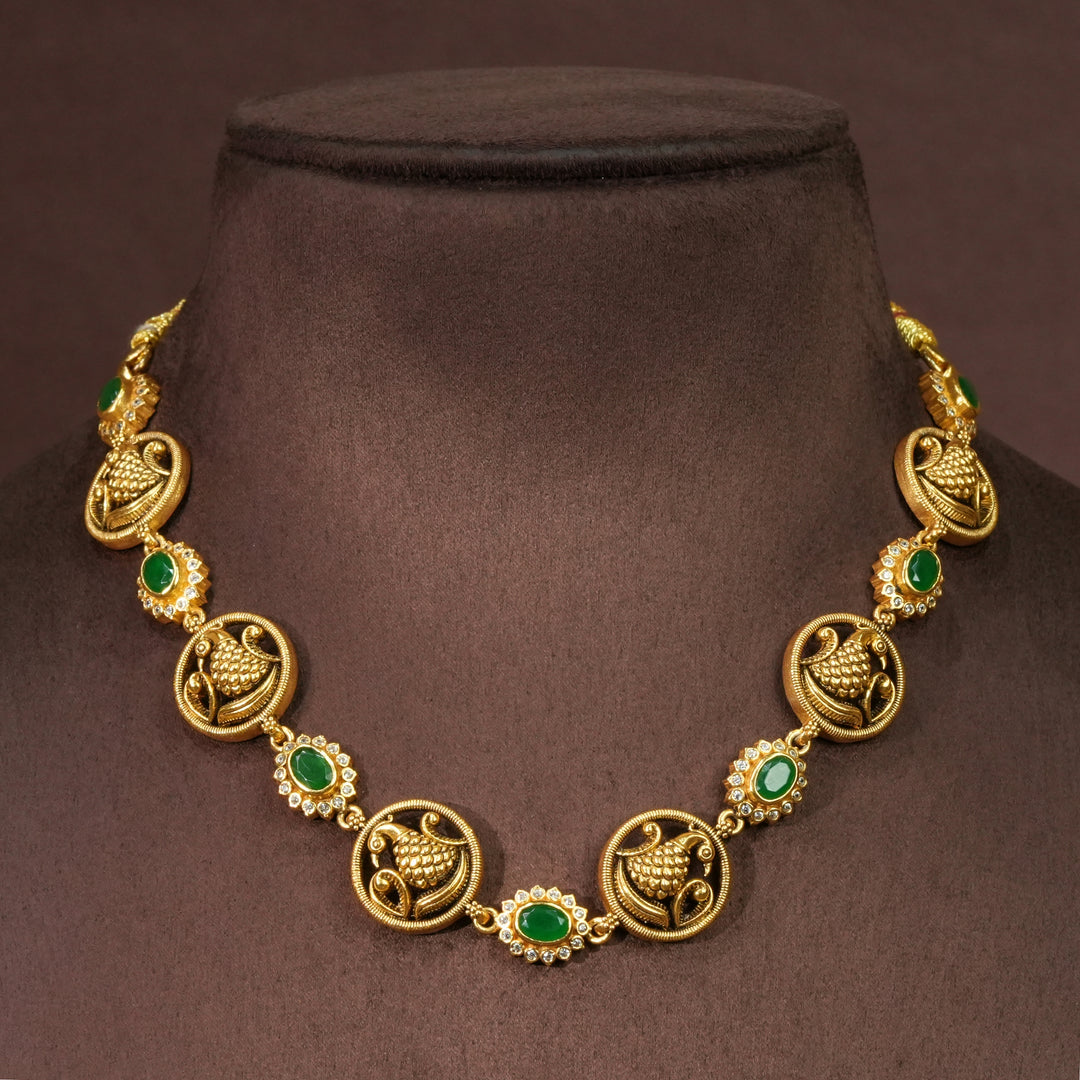 Elegant 92.5 silver temple necklace with emerald stone detailing and traditional peacock motifs by Sri Fine Jewellery Hyderabad.
(https://srifinejewellery.com)
