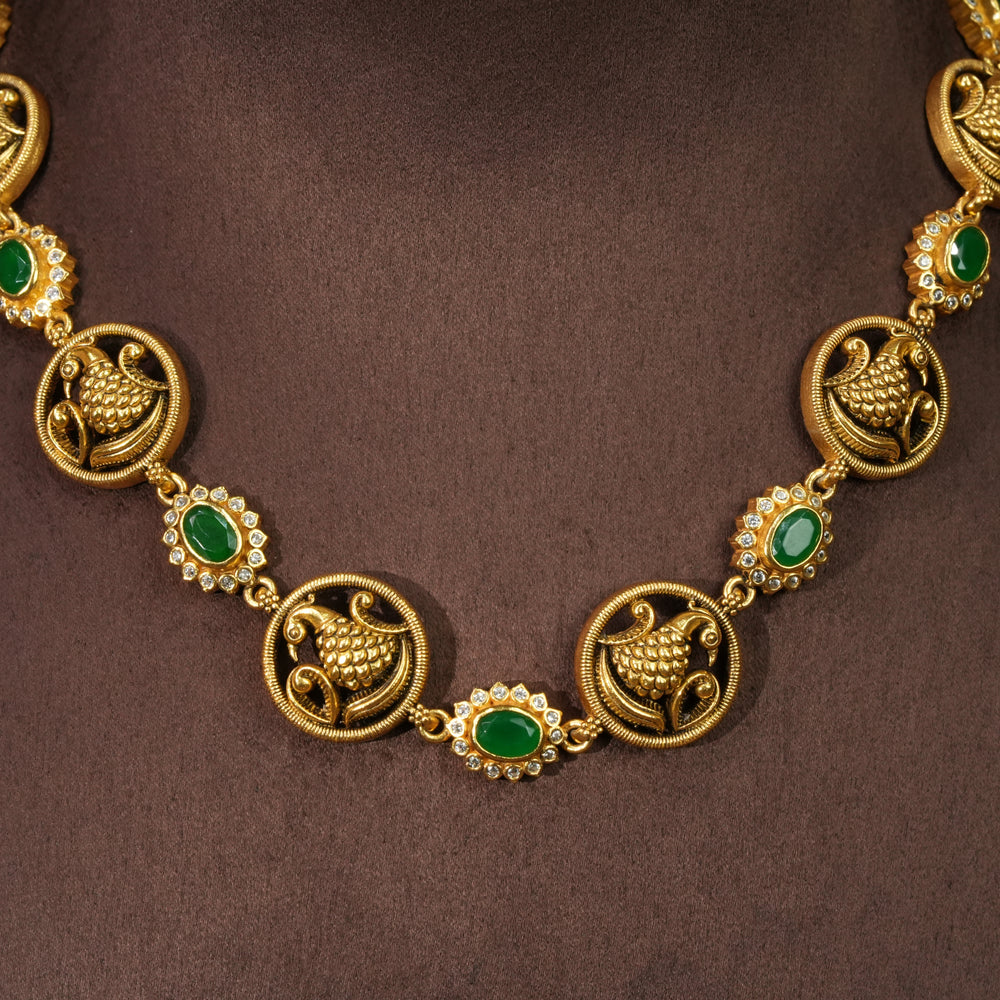 Elegant 92.5 silver temple necklace with emerald stone detailing and traditional peacock motifs by Sri Fine Jewellery Hyderabad.
(https://srifinejewellery.com)
