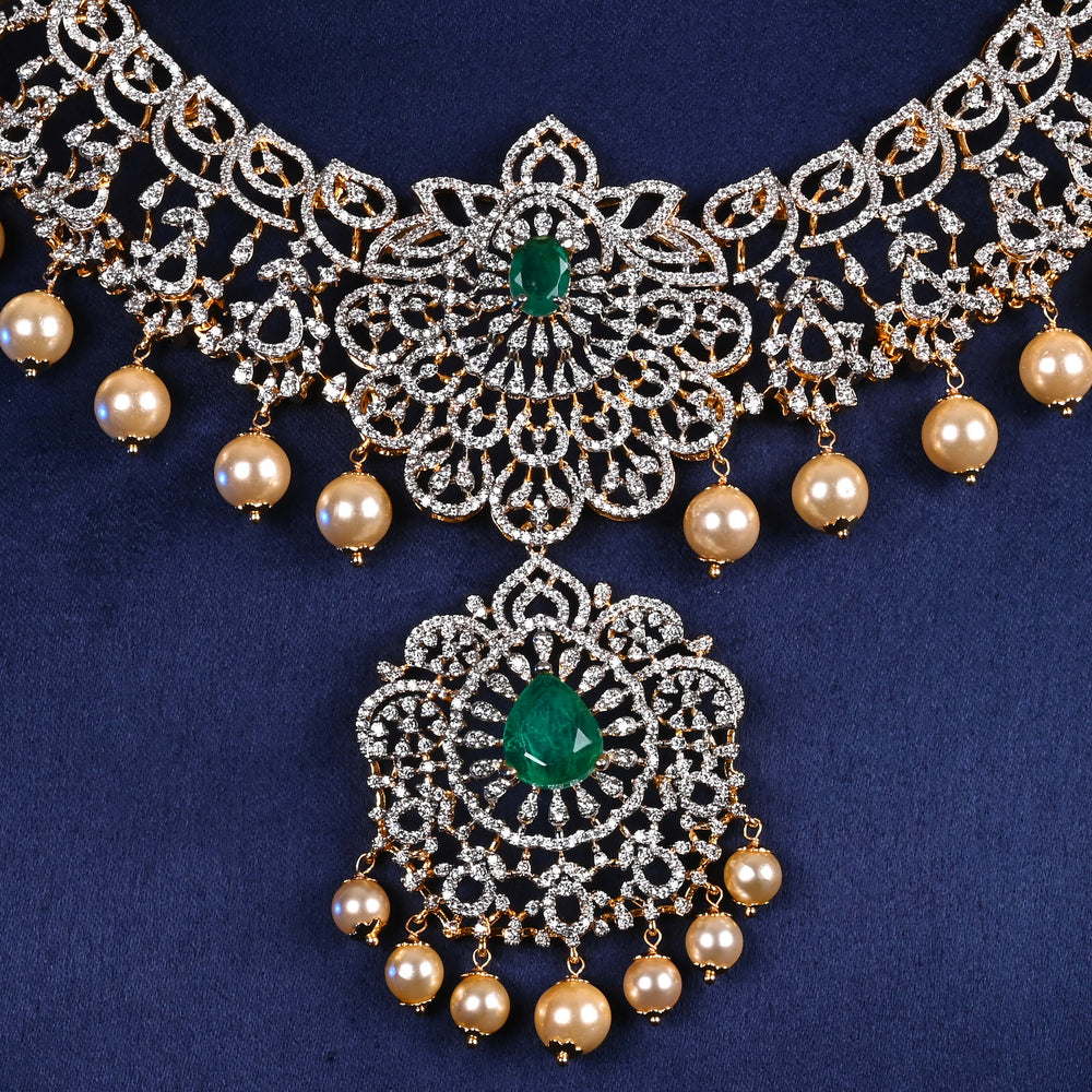 Close-up view of luxury diamond-look silver cz emerald necklace with premium cz stones, semi-precious emerald stone and  pearl drops in 92.5 silver, bridal wedding jewellery with gold finish by Sri Fine Jewellery Punjagutta Hyderabad.